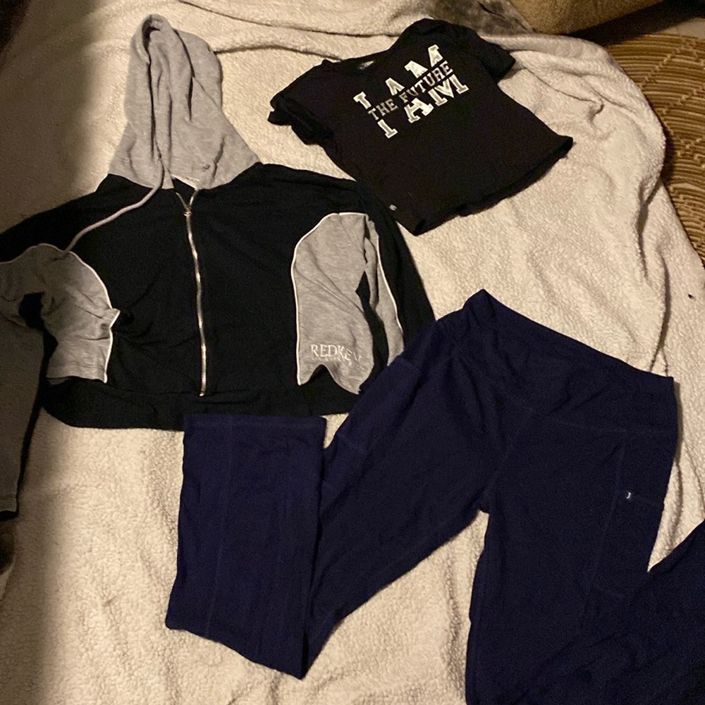 One black and grey sweater blue leggings and one kid shirt